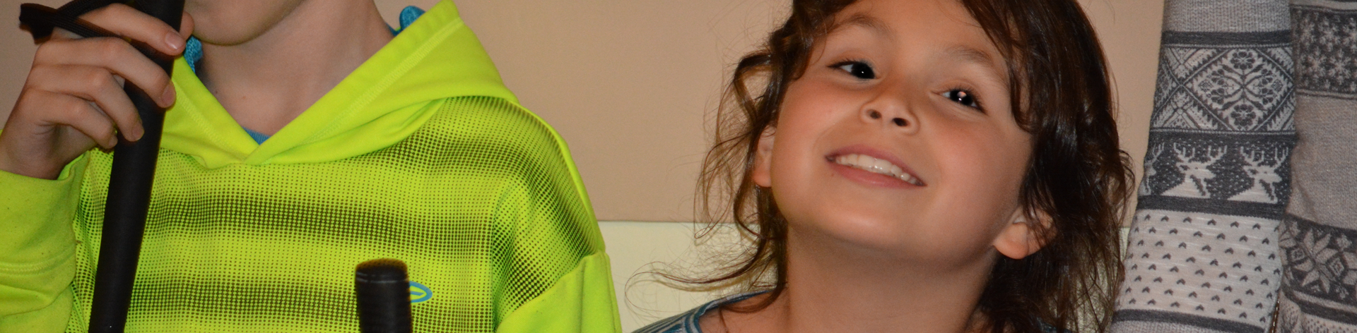 A young girl smiles widely.